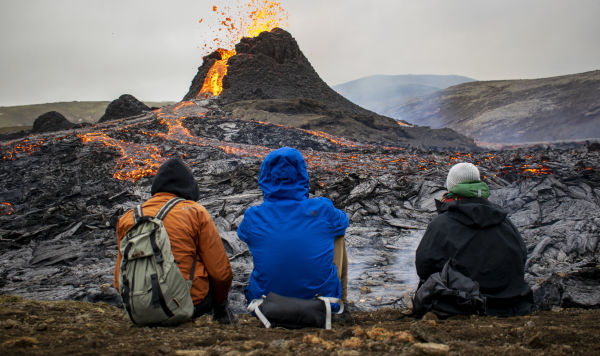 Туристы наблюдают за извержением вулкана на полуострове Рейкьянес в Исландии