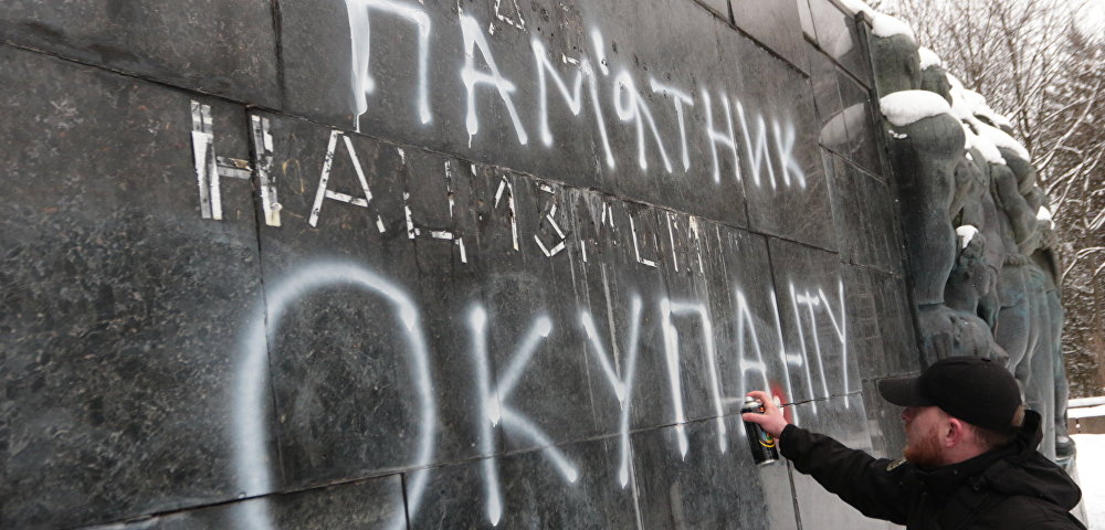 Националист наносит надпись "Памятник оккупанту" на Монумент Славы во Львове